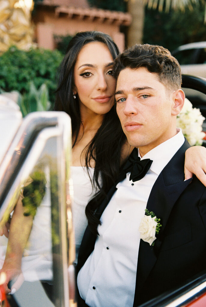 Bride and groom photographed in a car outside Sands Hotel Palm Springs